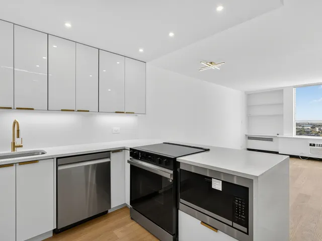 a view of kitchen with furniture and refrigerator