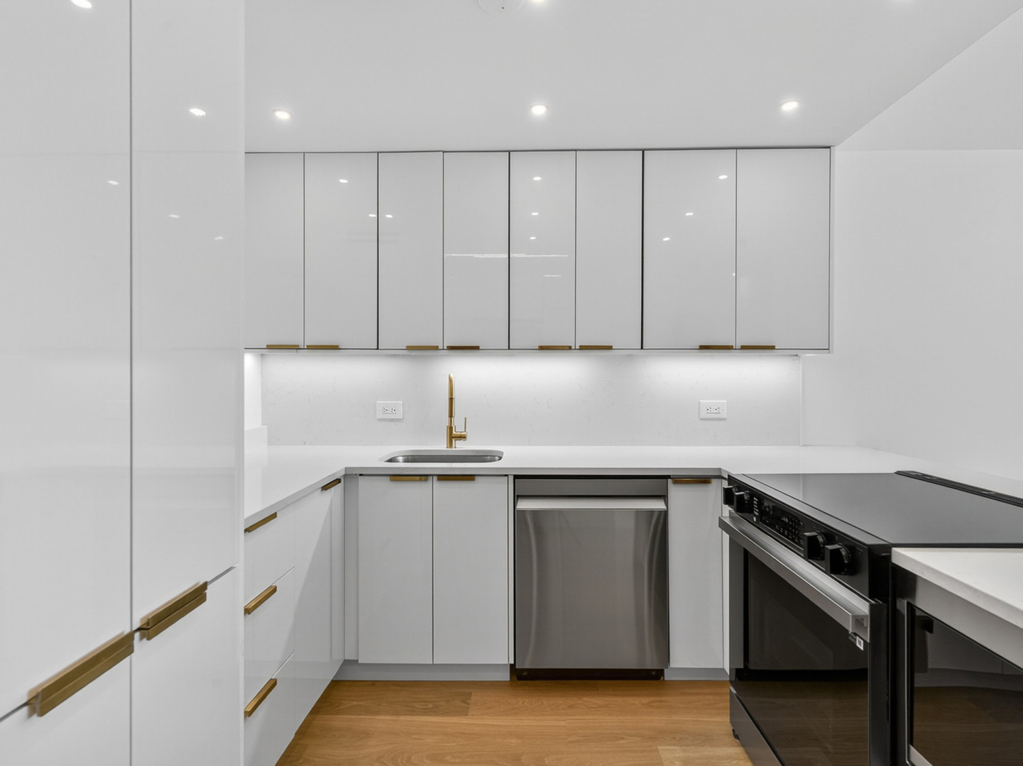 1455 North Sandburg Terrace, Unit 2403 Chicago, IL 60610 - Photo 15 of 22 a kitchen with stainless steel appliances white cabinets and a sink
