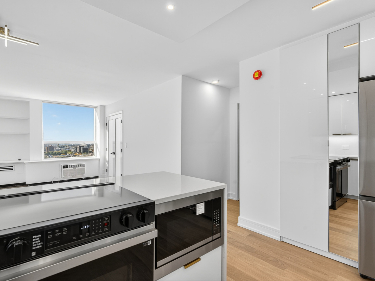 1455 North Sandburg Terrace, Unit 2403 Chicago, IL 60610 - Photo 16 of 22 a kitchen with a stove and a refrigerator