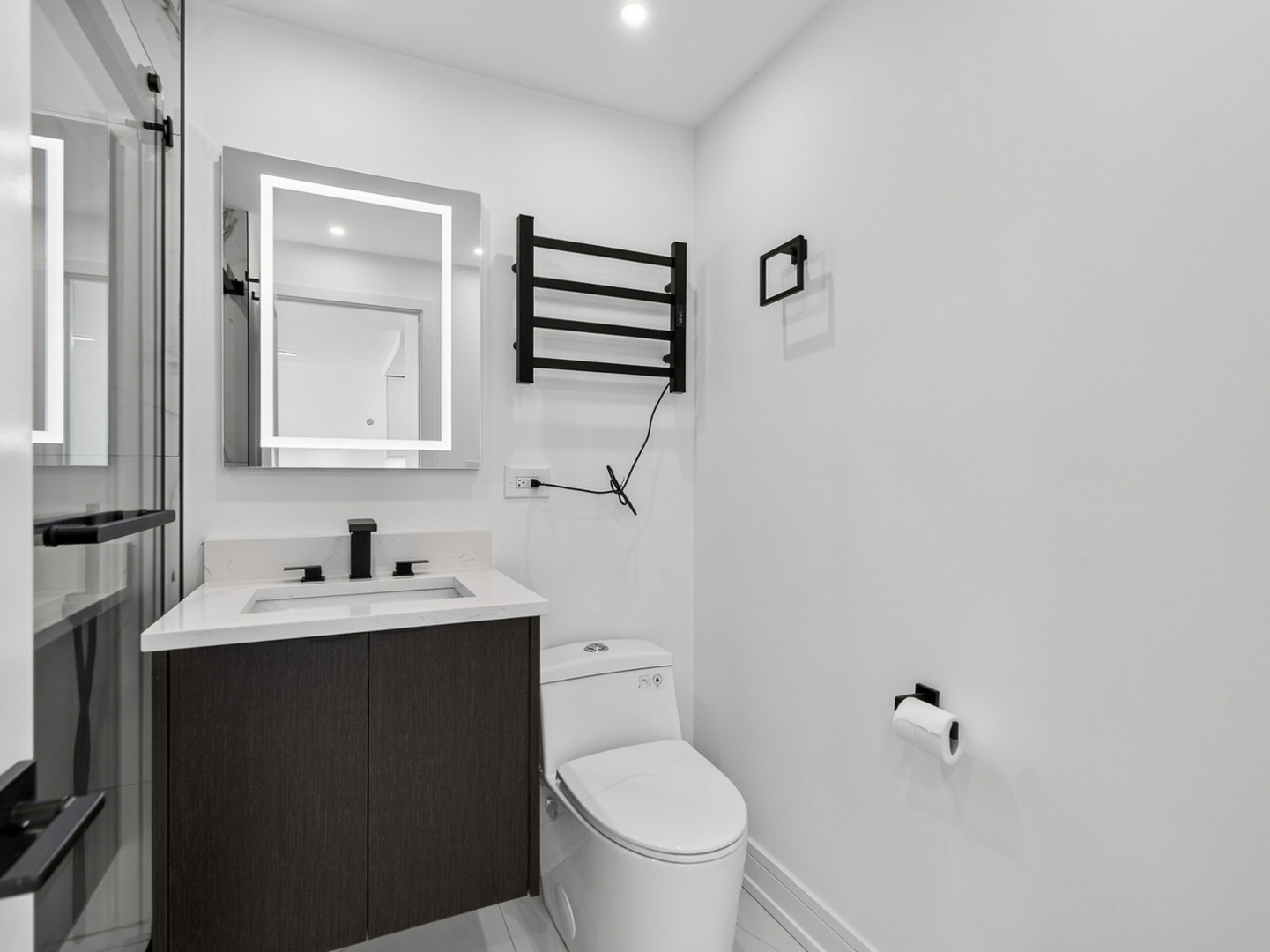 1455 North Sandburg Terrace, Unit 2403 Chicago, IL 60610 - Photo 18 of 22 a bathroom with a toilet sink and mirror
