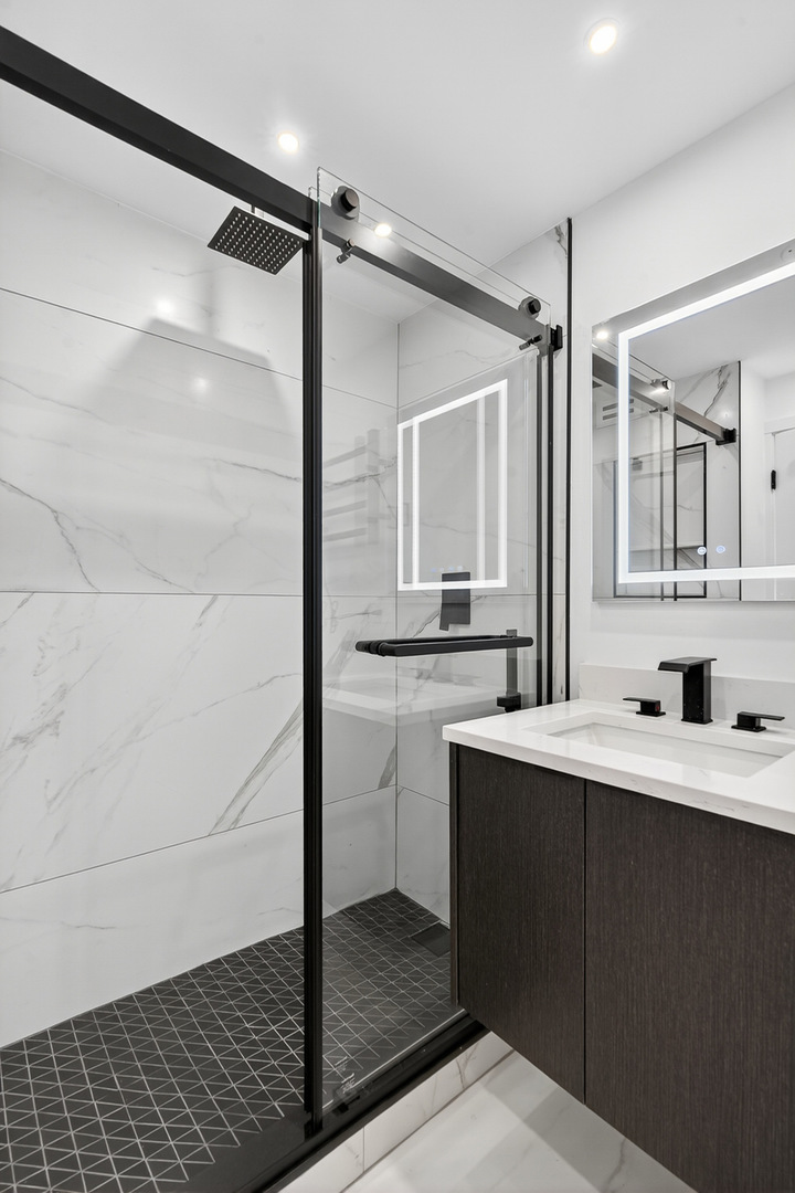 1455 North Sandburg Terrace, Unit 2403 Chicago, IL 60610 - Photo 20 of 22 a bathroom with a sink and a mirror