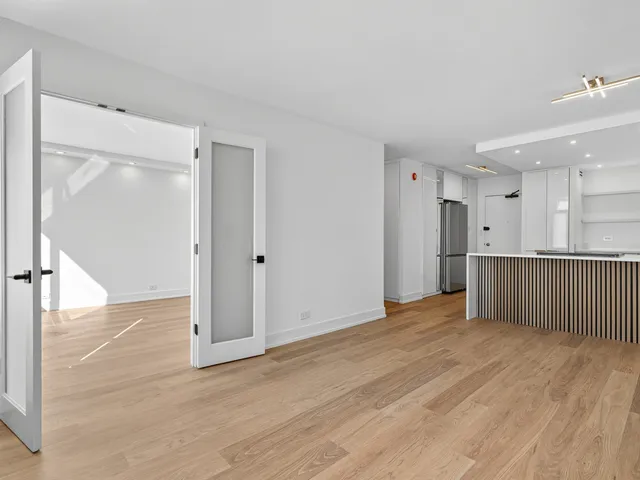 a bedroom with a large bed and a large window