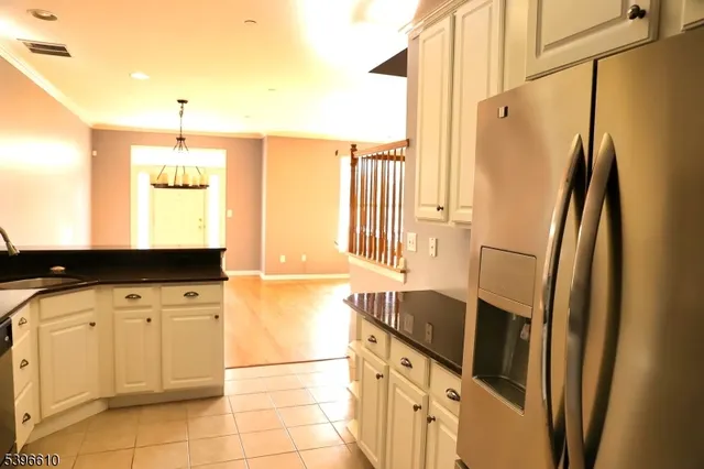 a kitchen with stainless steel appliances a refrigerator sink and cabinets