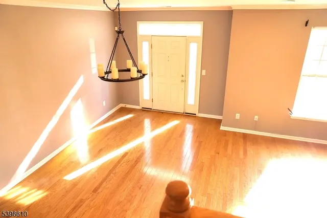 a view of a room with wooden floor and windows
