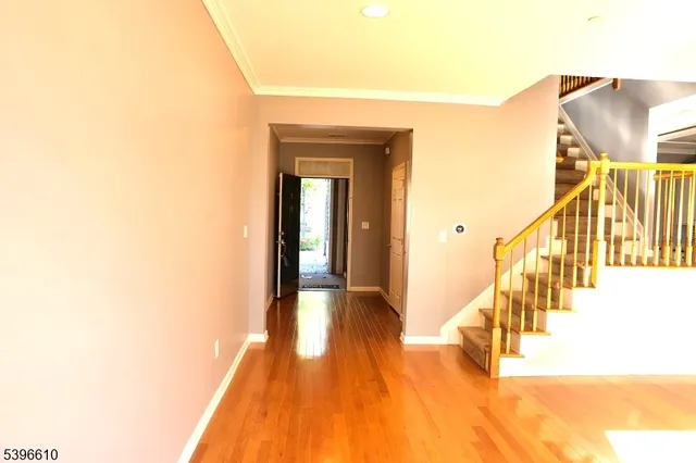 a view of hallway with wooden floor