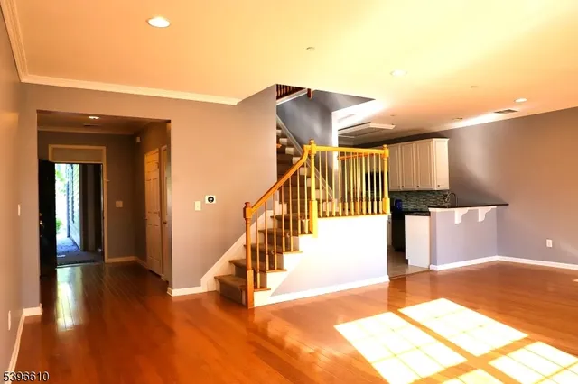 a view of entryway and hall with wooden floor