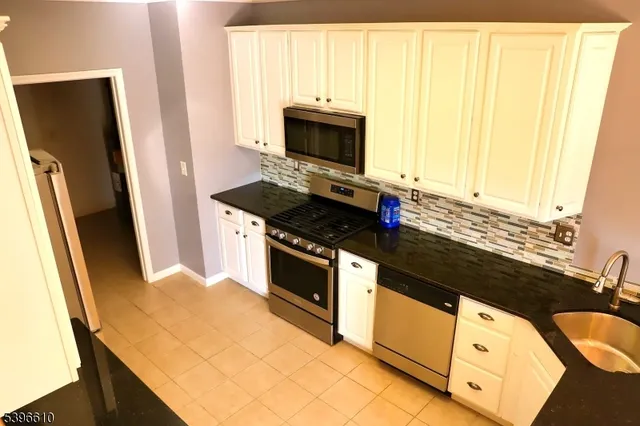 a kitchen with stainless steel appliances a stove microwave and refrigerator