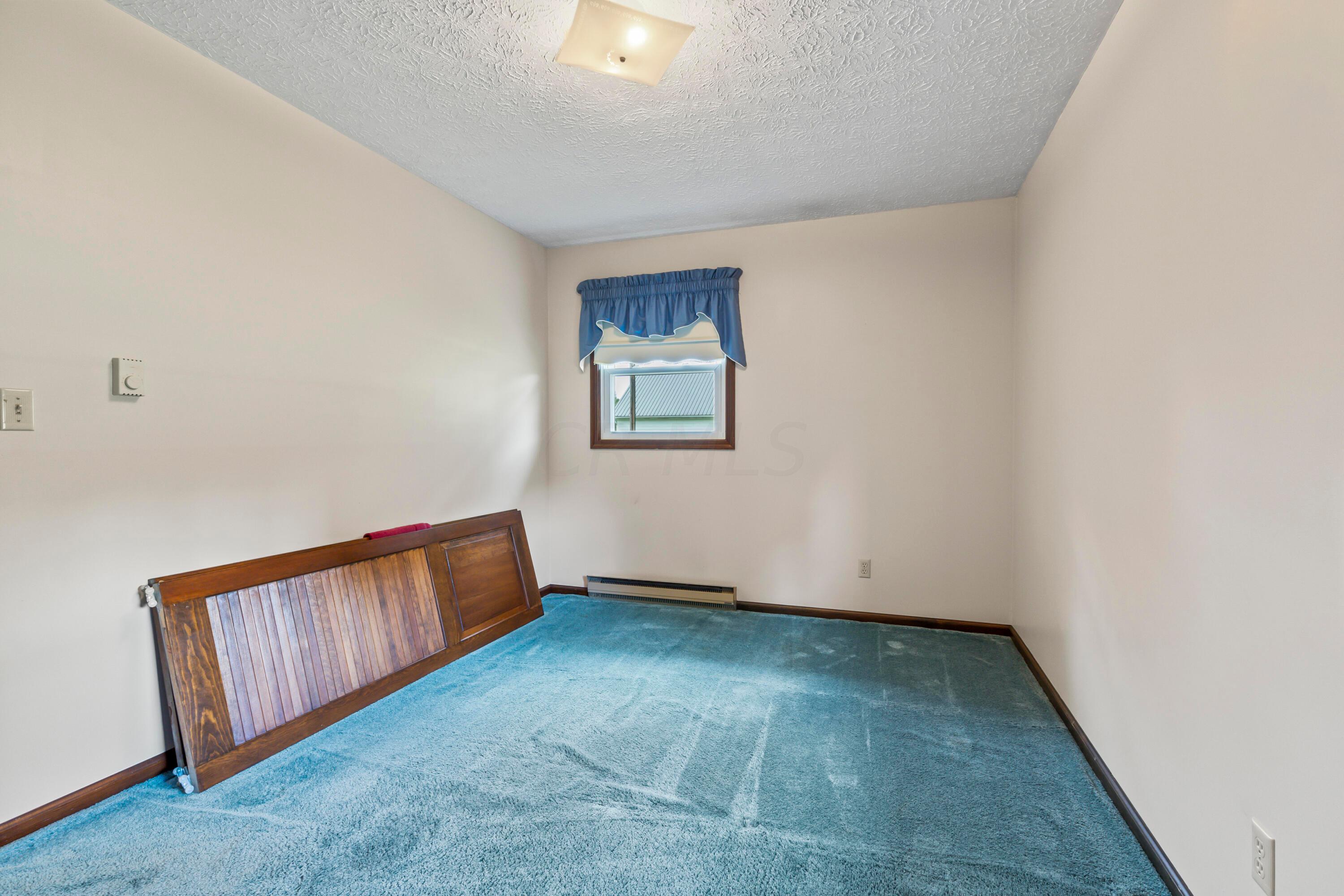 5764 Cheshire Road Galena, OH 43021 - Photo 23 of 59 • Blue carpet
• Tan painted walls
• Ceiling light
• Lighted closet with bi-fold
doors
• Shades