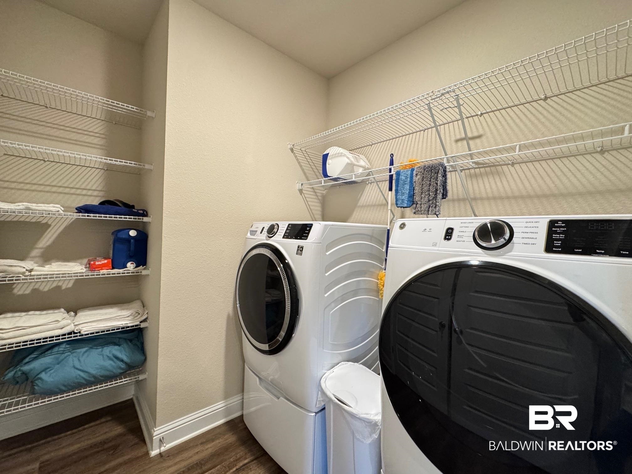 1346 Kairos Loop Foley, AL 36535 - Photo 17 of 40 Washroom with dark hardwood / wood-style floors and independent washer and dryer