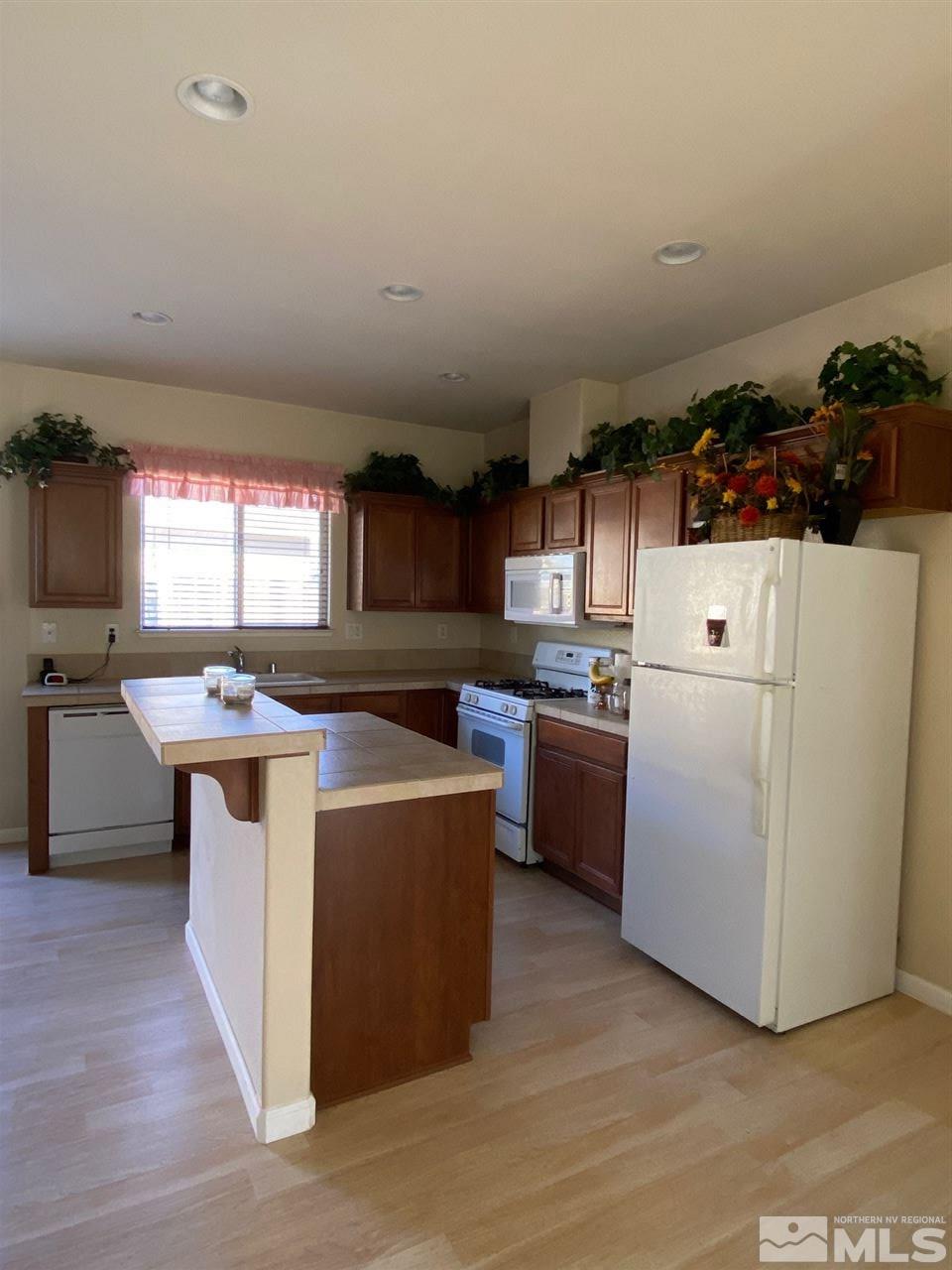 1375 Copper Leaf Drive Reno, NV 89506 - Photo 3 of 20 a kitchen with a sink stove and cabinets