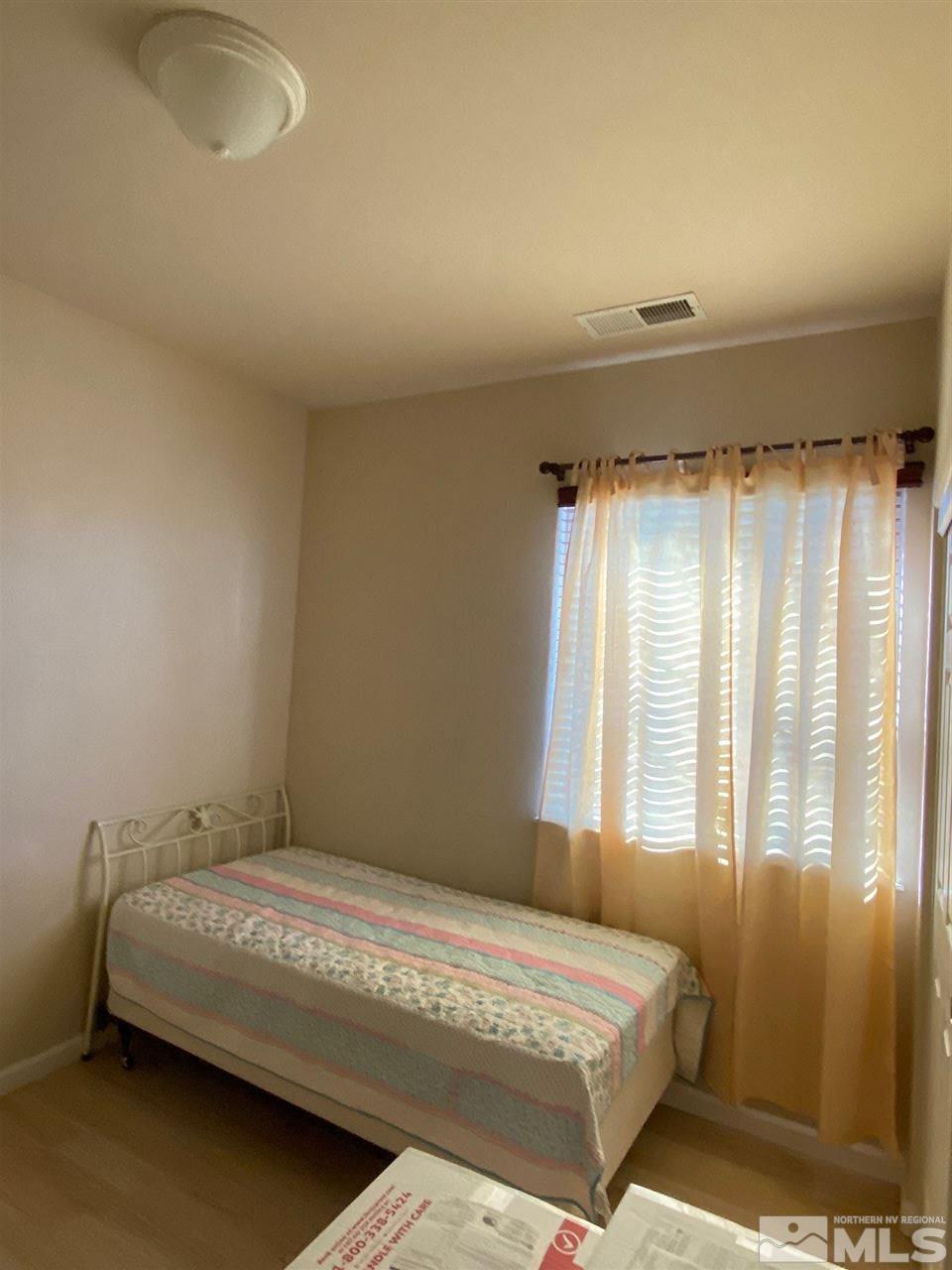 1375 Copper Leaf Drive Reno, NV 89506 - Photo 8 of 20 a bedroom with a bed and a window