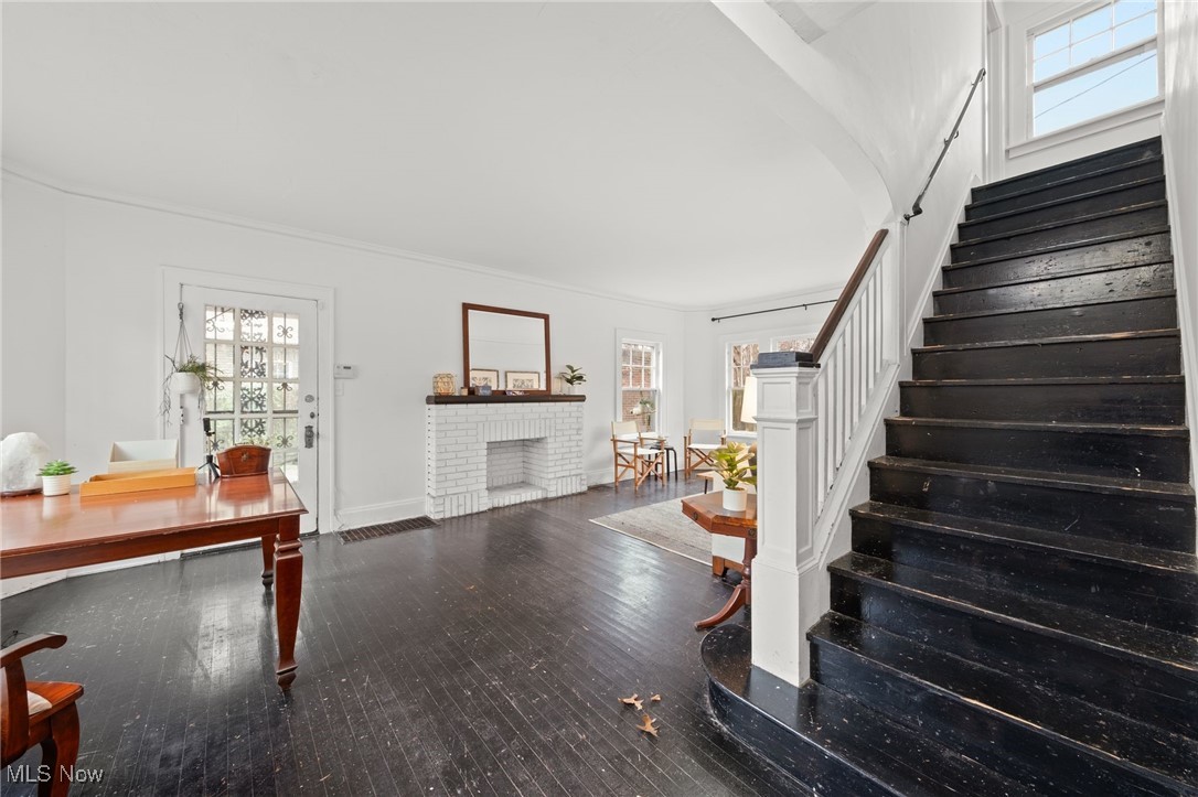 1857 Willowhurst Road Cleveland, OH 44112 - Photo 6 of 26 Stairs with hardwood / wood-style flooring, a brick fireplace, a wealth of natural light, and ornamental molding