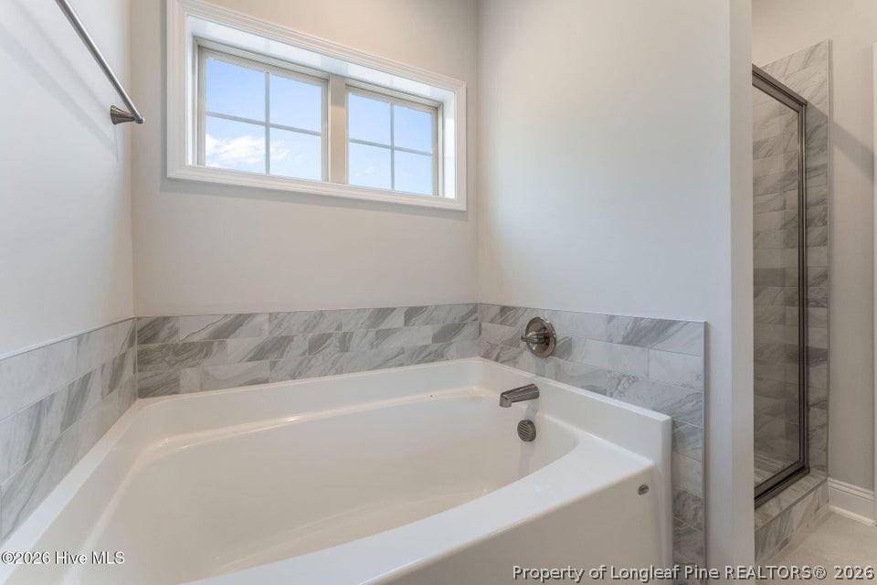 229 Telluride Court Aberdeen, NC 28315 - Photo 11 of 19 a bathroom with a bathtub