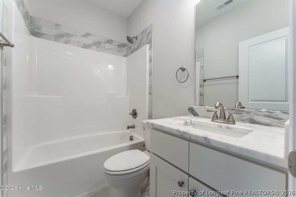 229 Telluride Court Aberdeen, NC 28315 - Photo 12 of 19 a bathroom with a sink a toilet and shower