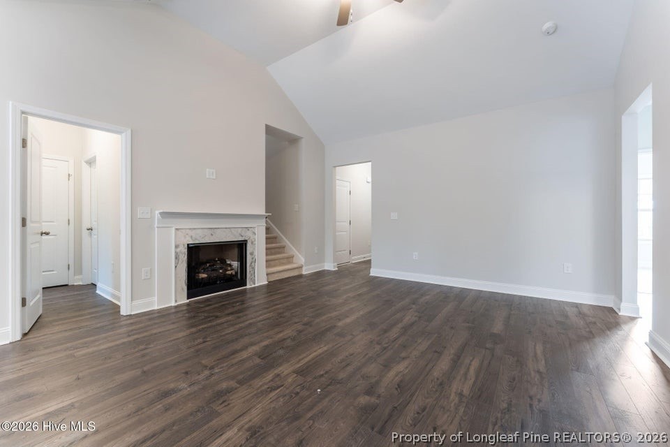229 Telluride Court Aberdeen, NC 28315 - Photo 6 of 19 a view of an empty room with wooden floor fireplace and a window