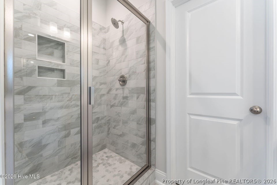 229 Telluride Court Aberdeen, NC 28315 - Photo 10 of 19 a bathroom with a glass shower door