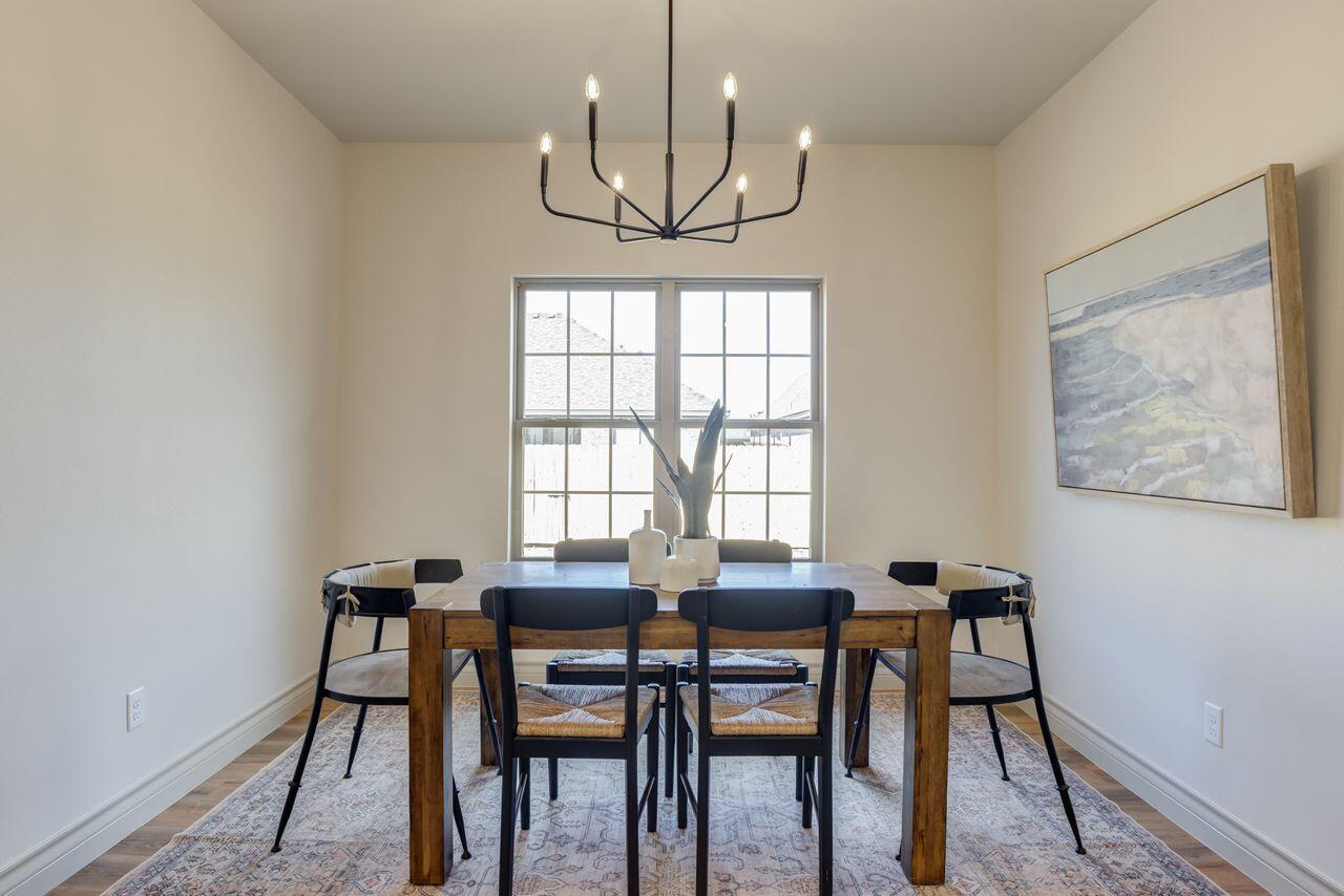 5524 120th Street Lubbock, TX 79424 - Photo 21 of 39 a view of a dining room with furniture window and wooden floor
