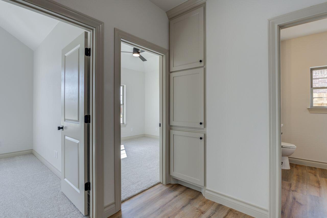 5524 120th Street Lubbock, TX 79424 - Photo 25 of 39 a view of a bathroom with toilet front door and hallway