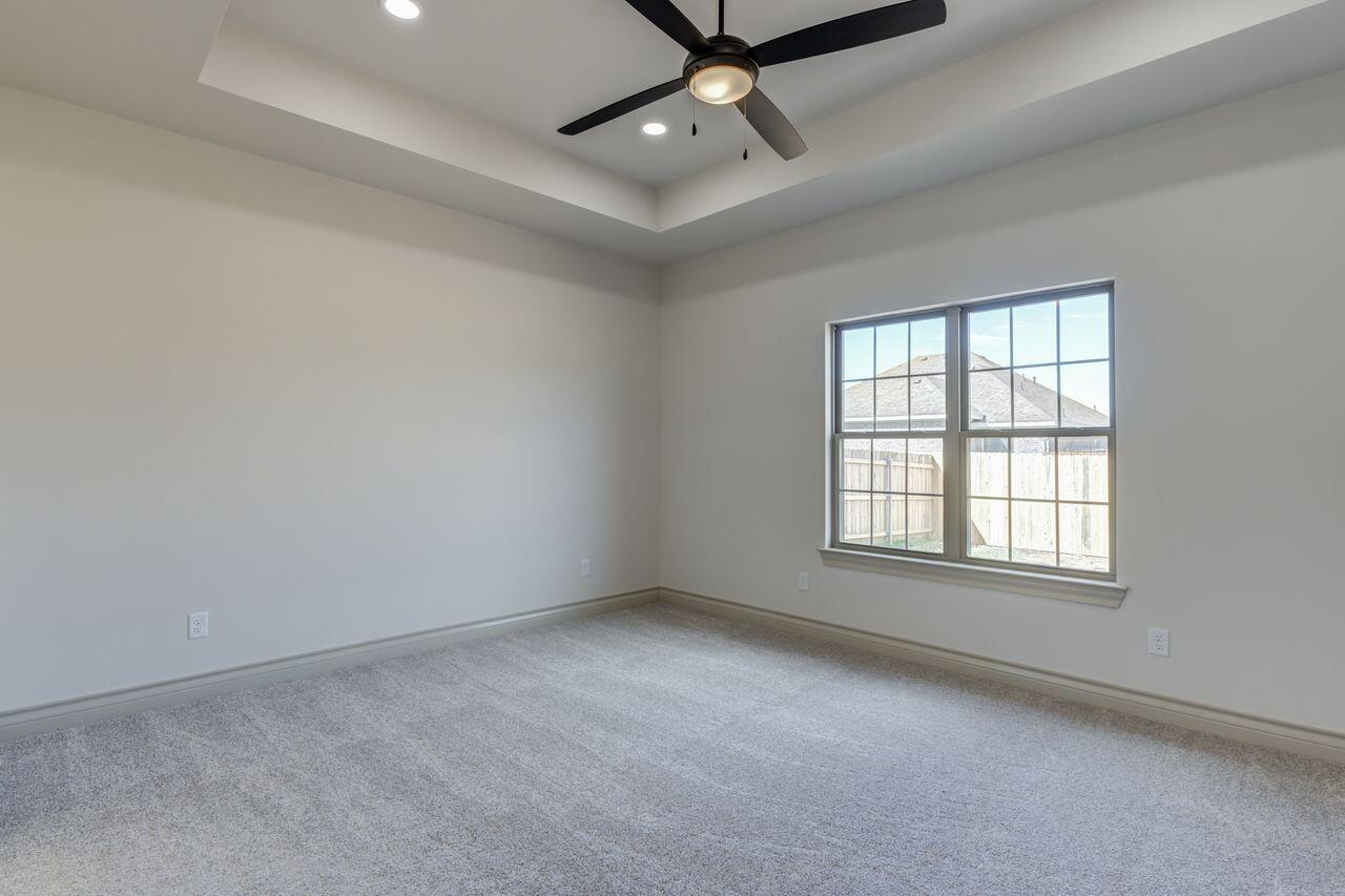 5524 120th Street Lubbock, TX 79424 - Photo 30 of 39 an empty room with a window and ceiling fan