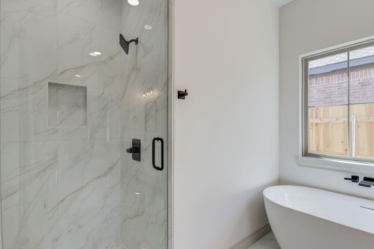 5524 120th Street Lubbock, TX 79424 - Photo 36 of 39 a bathroom with a tub and shower