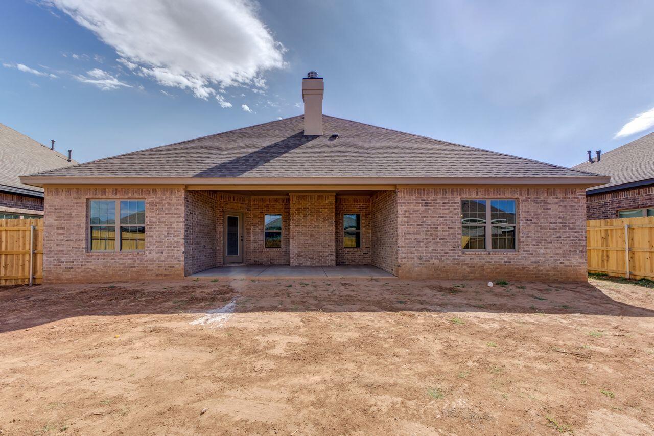 5524 120th Street Lubbock, TX 79424 - Photo 39 of 39 a front view of a house with a yard and garage