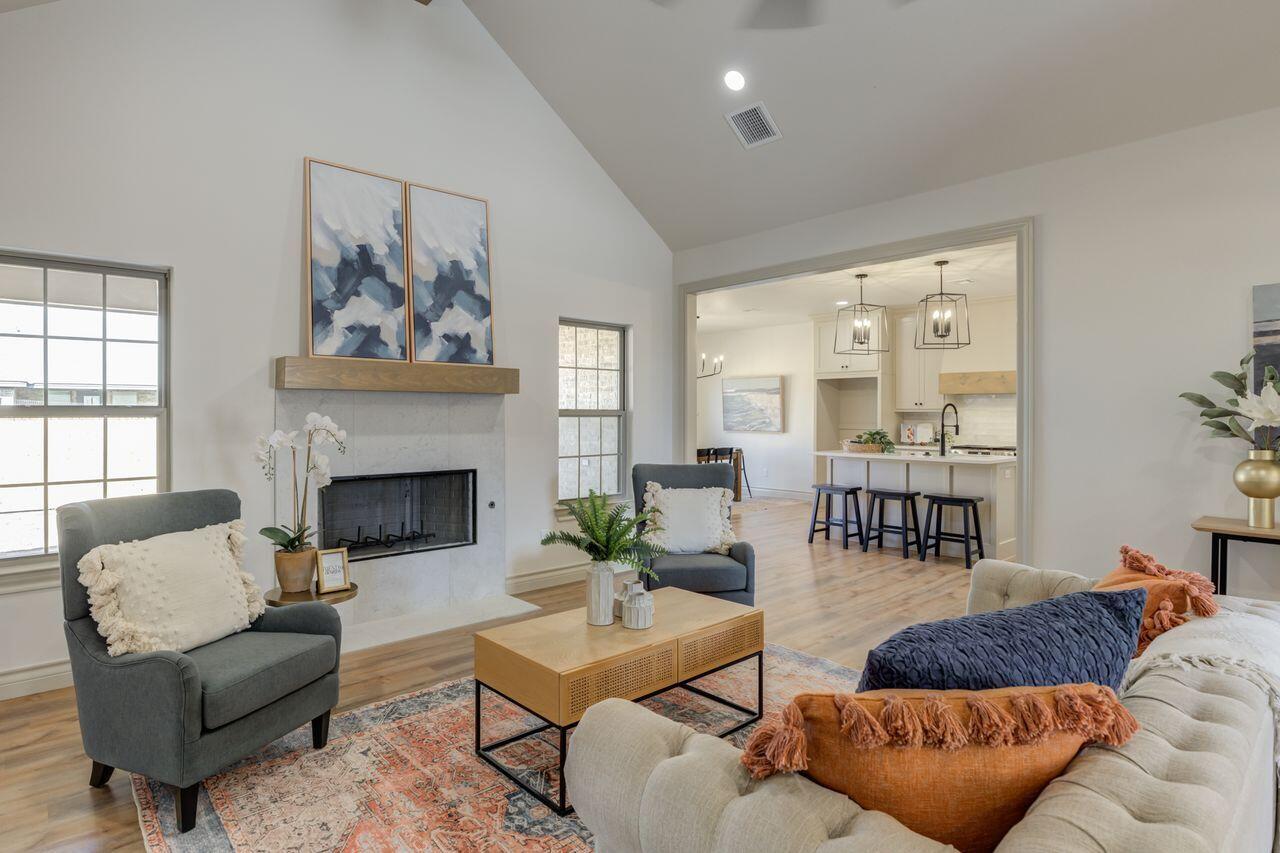 5524 120th Street Lubbock, TX 79424 - Photo 5 of 39 a living room with furniture and a fireplace