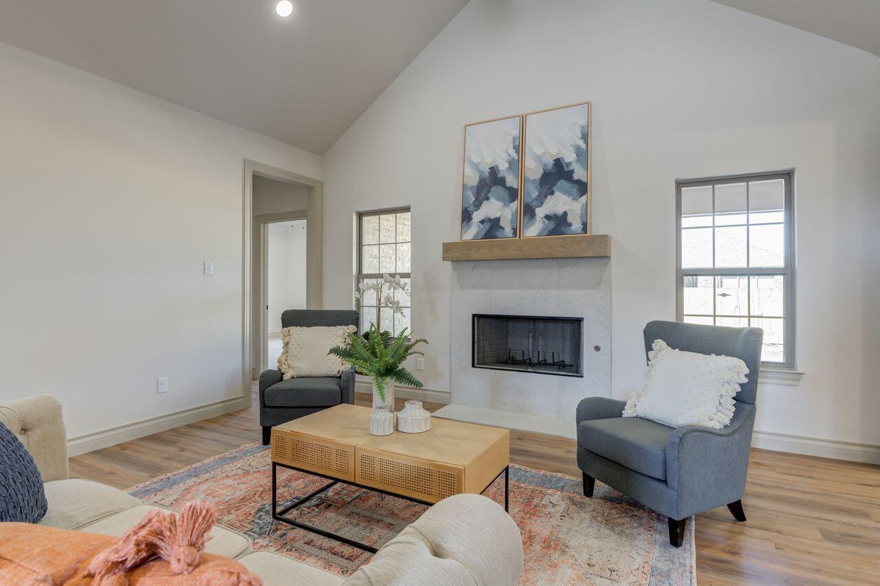 5524 120th Street Lubbock, TX 79424 - Photo 6 of 39 a living room with furniture potted plant and a fireplace