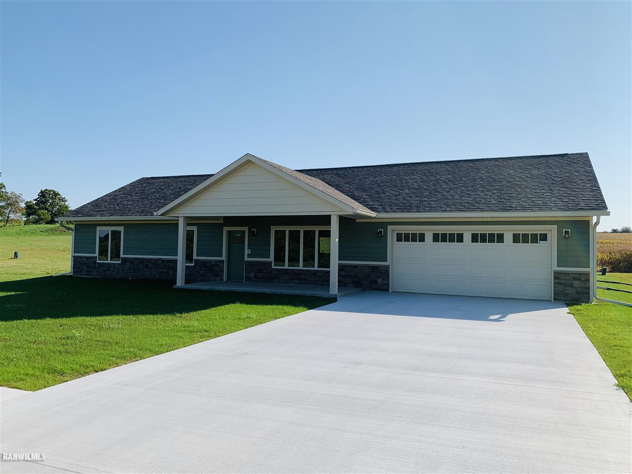 a front view of a house with yard and green space