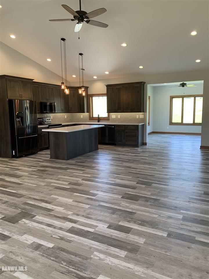 407 Oak Ridge Drive Lena, IL 61048 - Photo 13 of 50 a view of kitchen with kitchen island microwave and stove