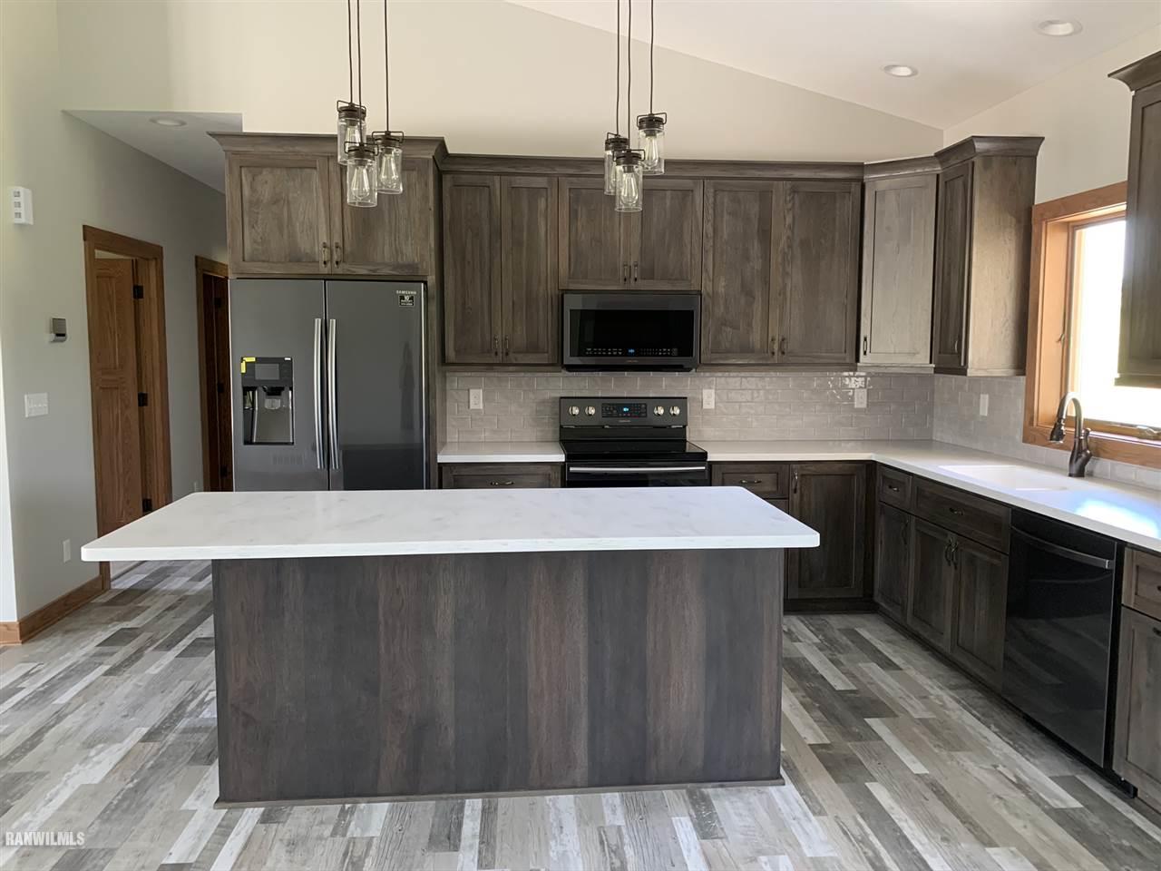 407 Oak Ridge Drive Lena, IL 61048 - Photo 16 of 50 a kitchen with kitchen island a sink dishwasher a refrigerator and a stove with wooden floor