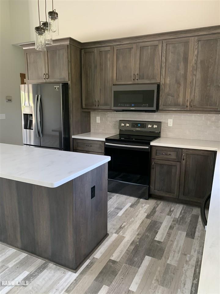 407 Oak Ridge Drive Lena, IL 61048 - Photo 17 of 50 a kitchen with stainless steel appliances a stove a refrigerator and a sink