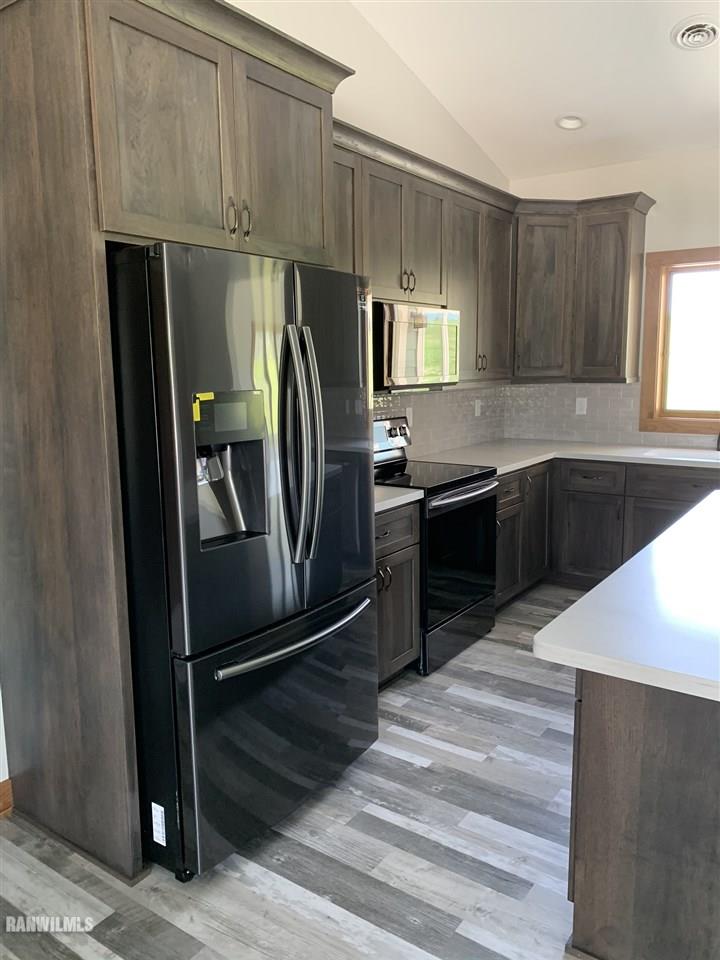 407 Oak Ridge Drive Lena, IL 61048 - Photo 18 of 50 a kitchen with stainless steel appliances granite countertop a refrigerator and a sink