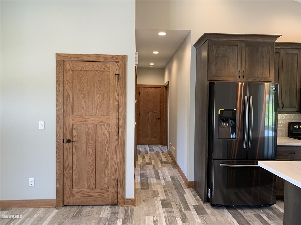 407 Oak Ridge Drive Lena, IL 61048 - Photo 20 of 50 a view of a refrigerator in kitchen and wooden floor