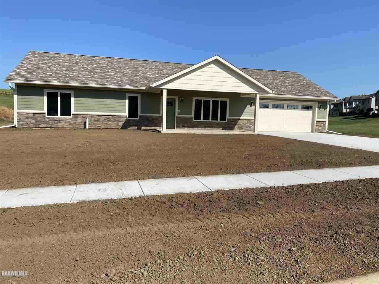 407 Oak Ridge Drive Lena, IL 61048 - Photo 2 of 50 a front view of a house with a yard and garage