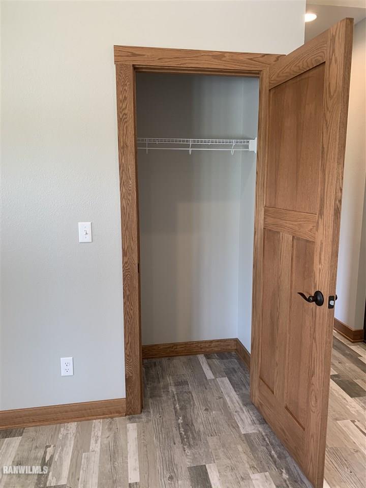407 Oak Ridge Drive Lena, IL 61048 - Photo 21 of 50 a view of an empty room with wooden floor and closet