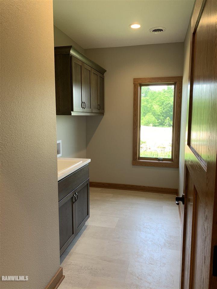 407 Oak Ridge Drive Lena, IL 61048 - Photo 26 of 50 a view of an empty room with a fireplace and a window