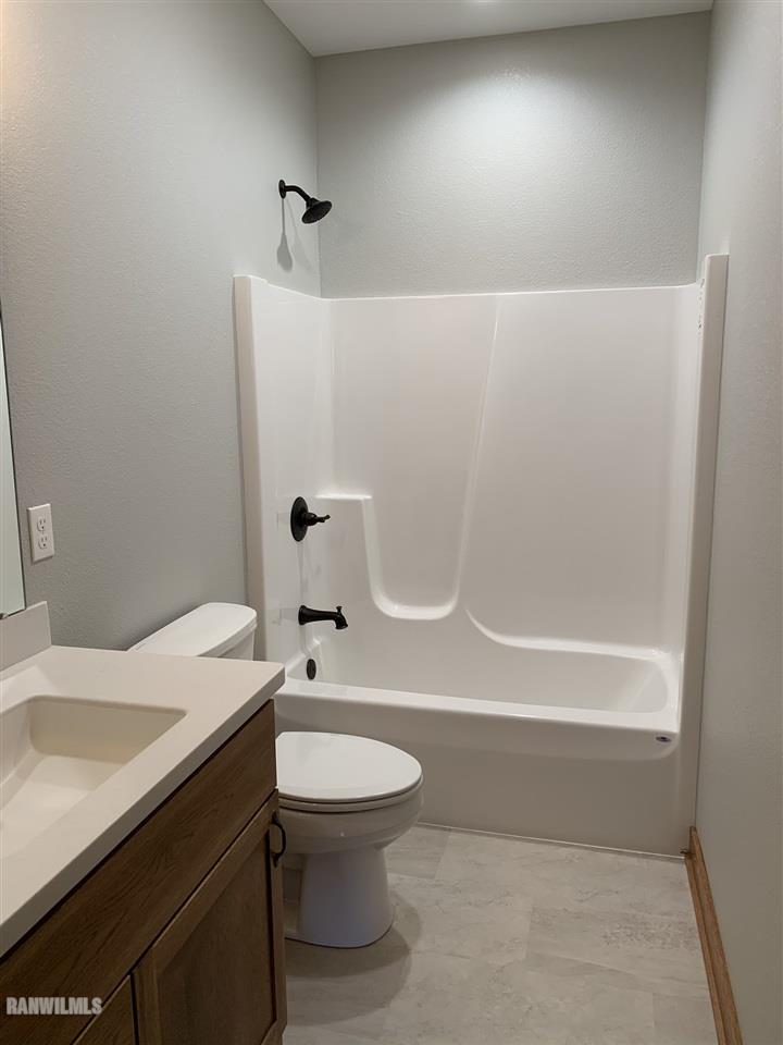 407 Oak Ridge Drive Lena, IL 61048 - Photo 30 of 50 a bathroom with a sink a toilet and shower