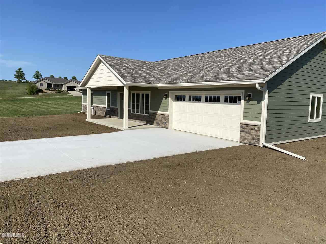 407 Oak Ridge Drive Lena, IL 61048 - Photo 3 of 50 a front view of a house with a yard and garage