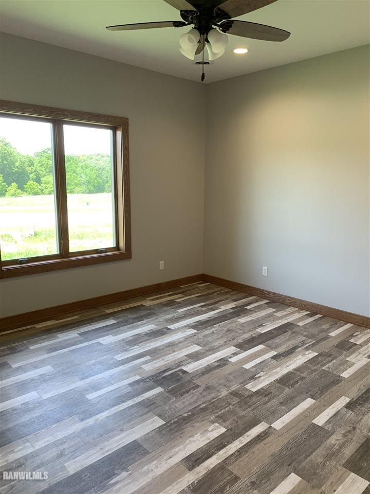 407 Oak Ridge Drive Lena, IL 61048 - Photo 32 of 50 a view of a livingroom with a ceiling fan and window