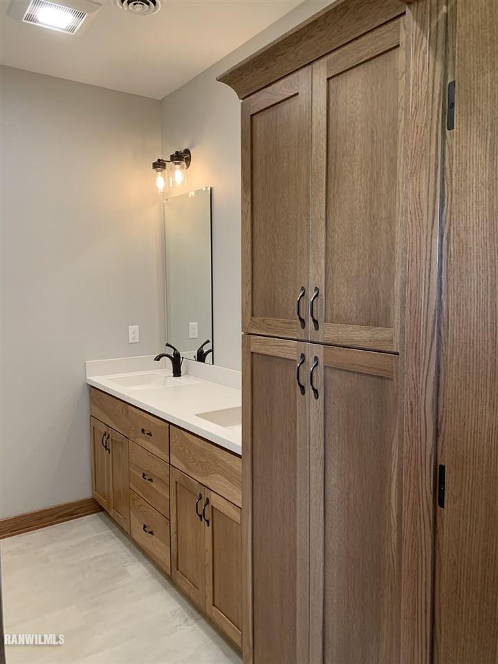 407 Oak Ridge Drive Lena, IL 61048 - Photo 42 of 50 a bathroom with a double vanity sink a mirror and a shower