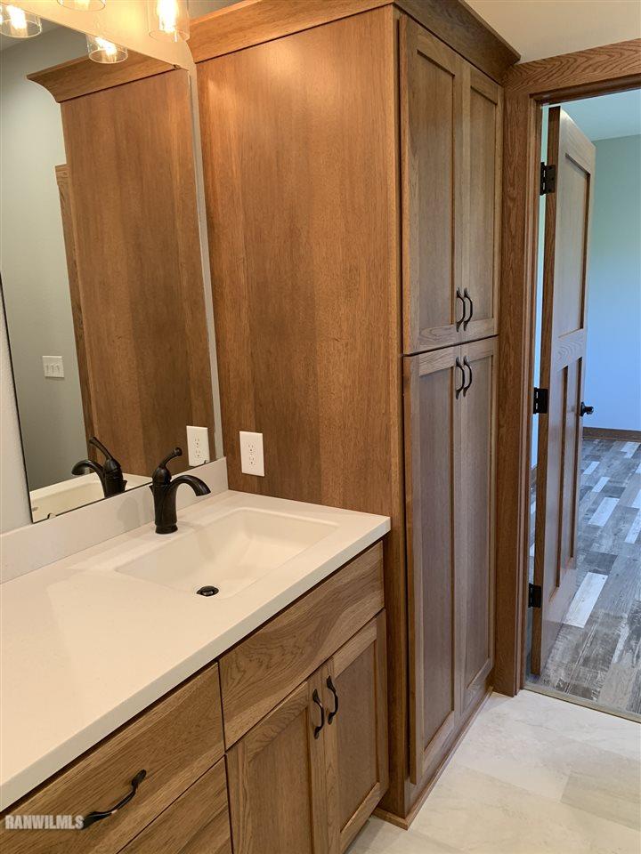 407 Oak Ridge Drive Lena, IL 61048 - Photo 43 of 50 a bathroom with a sink and a mirror
