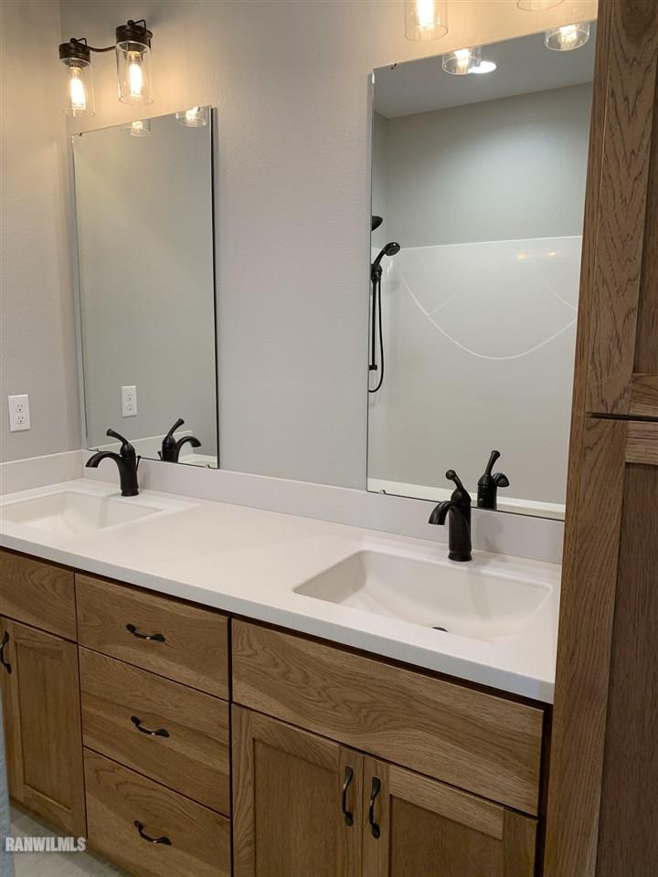 407 Oak Ridge Drive Lena, IL 61048 - Photo 44 of 50 a bathroom with a sink and a mirror