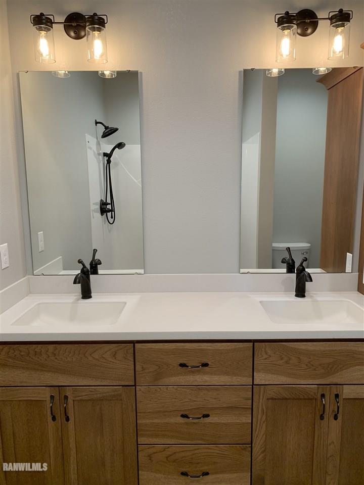 407 Oak Ridge Drive Lena, IL 61048 - Photo 45 of 50 a bathroom with a sink and a mirror