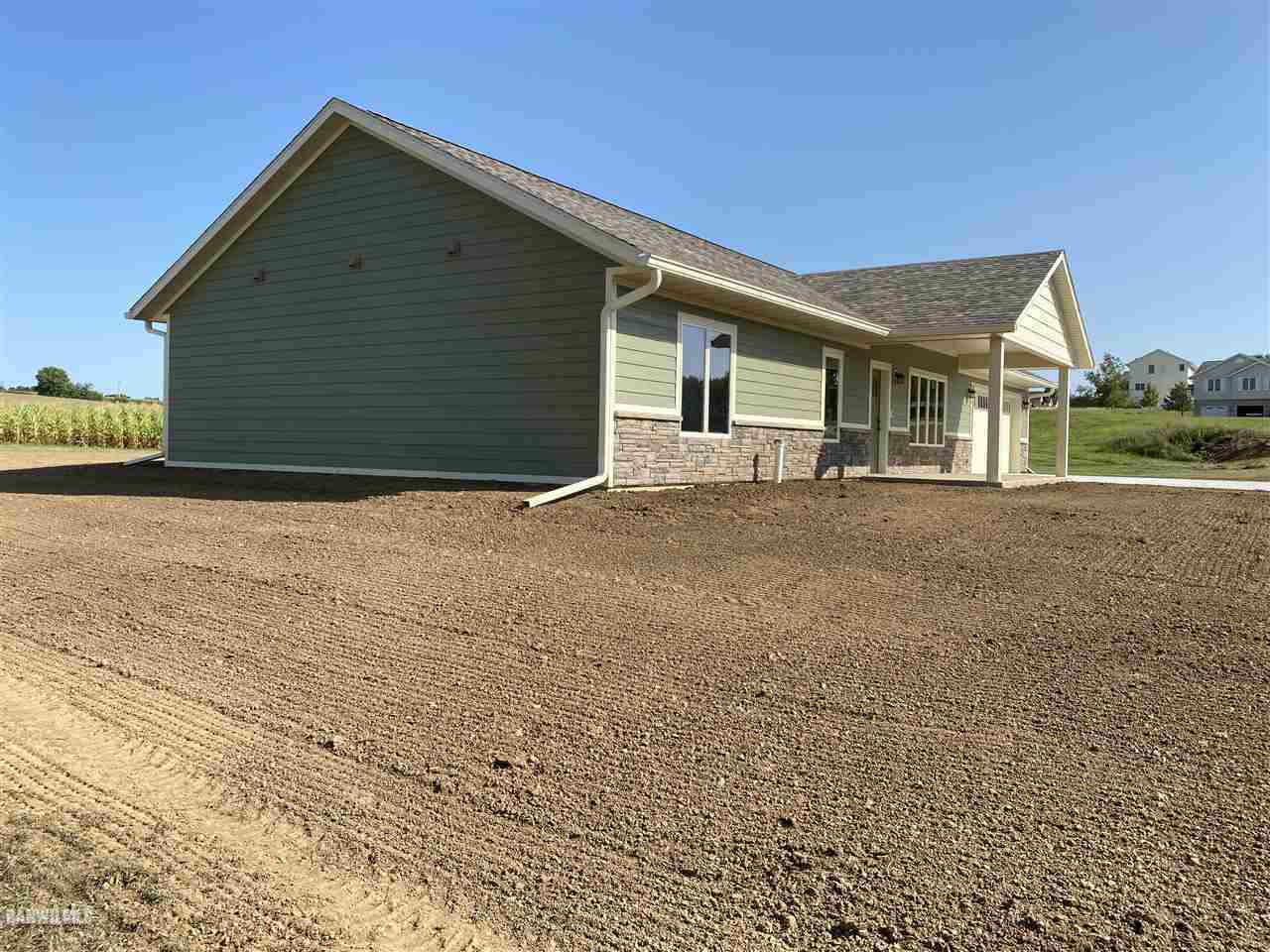 407 Oak Ridge Drive Lena, IL 61048 - Photo 8 of 50 a front view of a house with a yard and garage