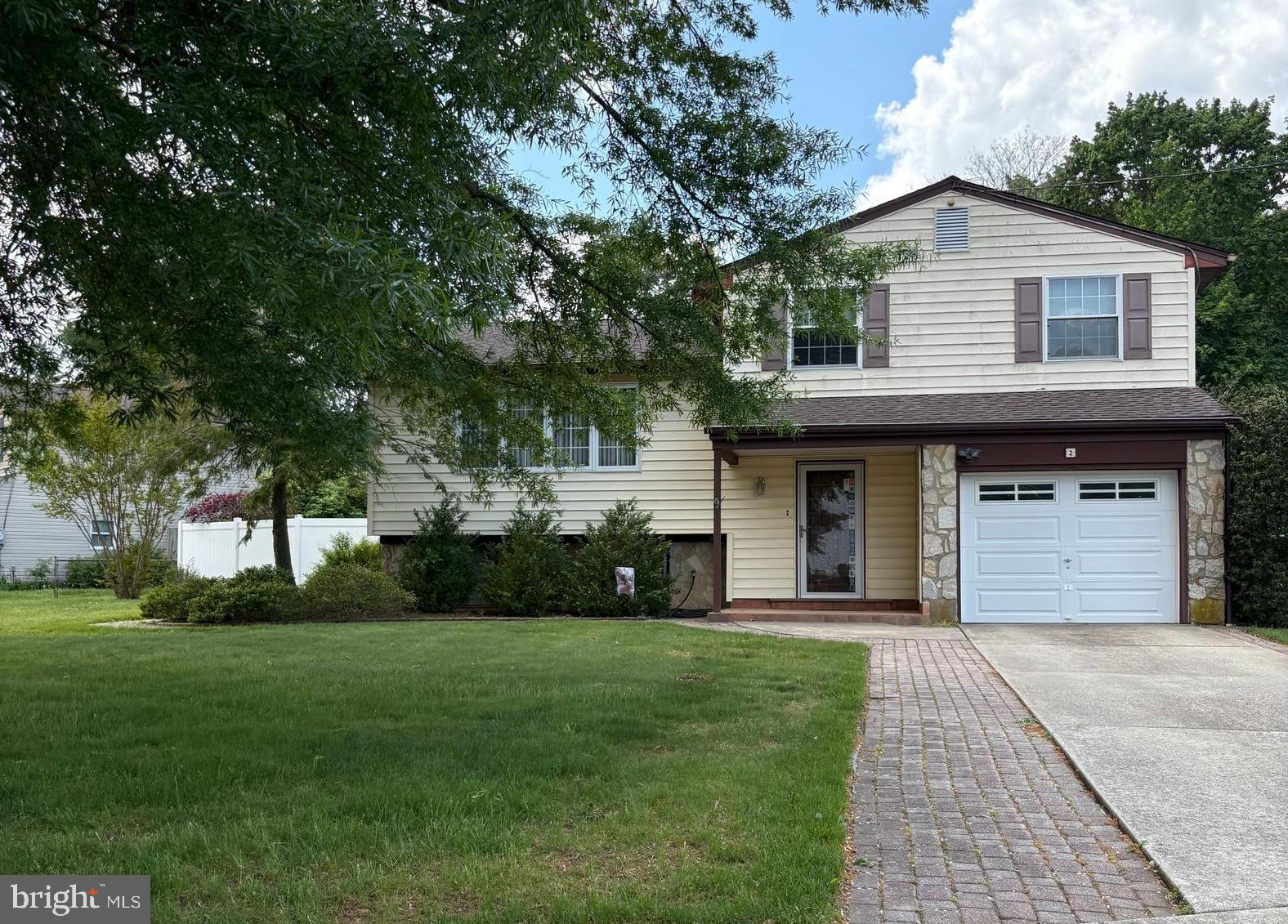 2 Tomahawk Drive Marlton, NJ 08053 - Photo 1 of 26 a front view of a house with a garden and trees