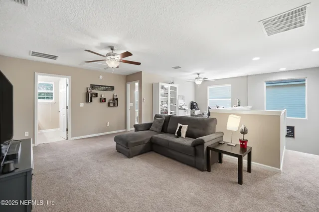 a bedroom with a dresser and a chandelier
