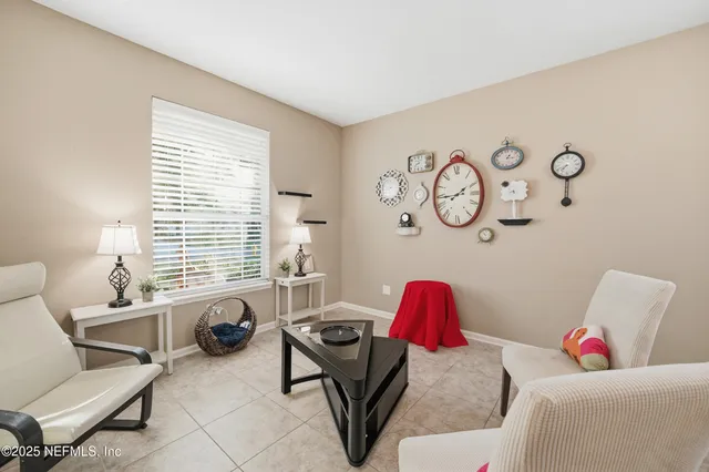 a living room with furniture flowers and a chandelier
