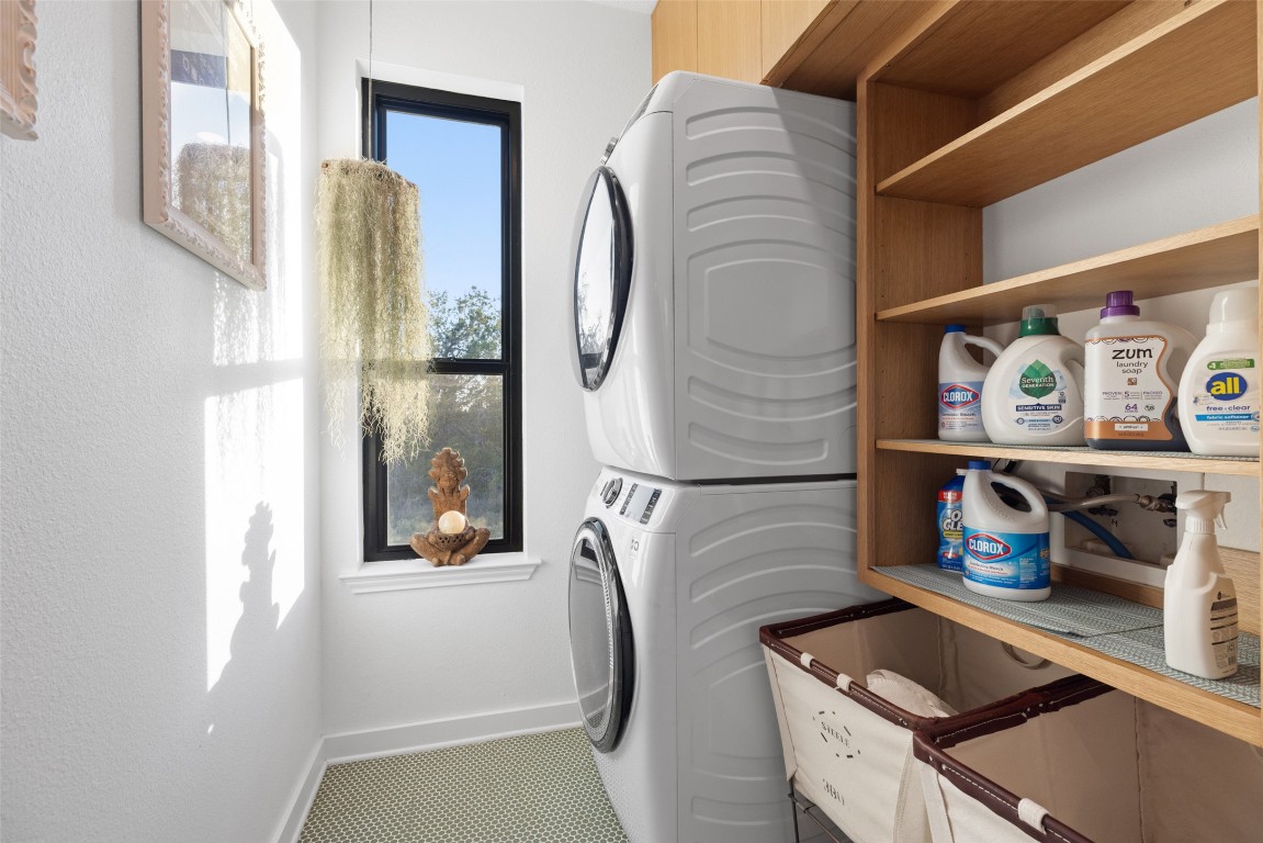120 Oak Springs Drive Dripping Springs, TX 78620 - Photo 15 of 35 Laundry room with stacked washer / drying machine and tile patterned flooring