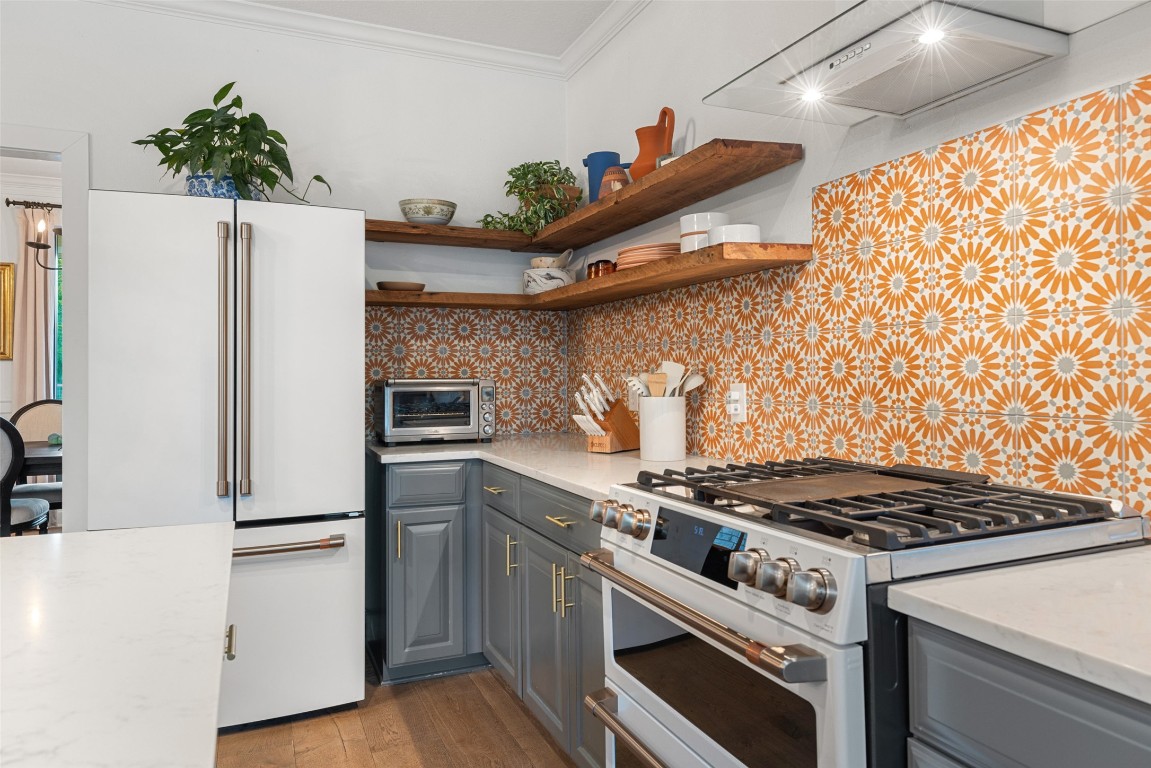 120 Oak Springs Drive Dripping Springs, TX 78620 - Photo 23 of 35 a kitchen with stainless steel appliances a stove a refrigerator and a refrigerator
