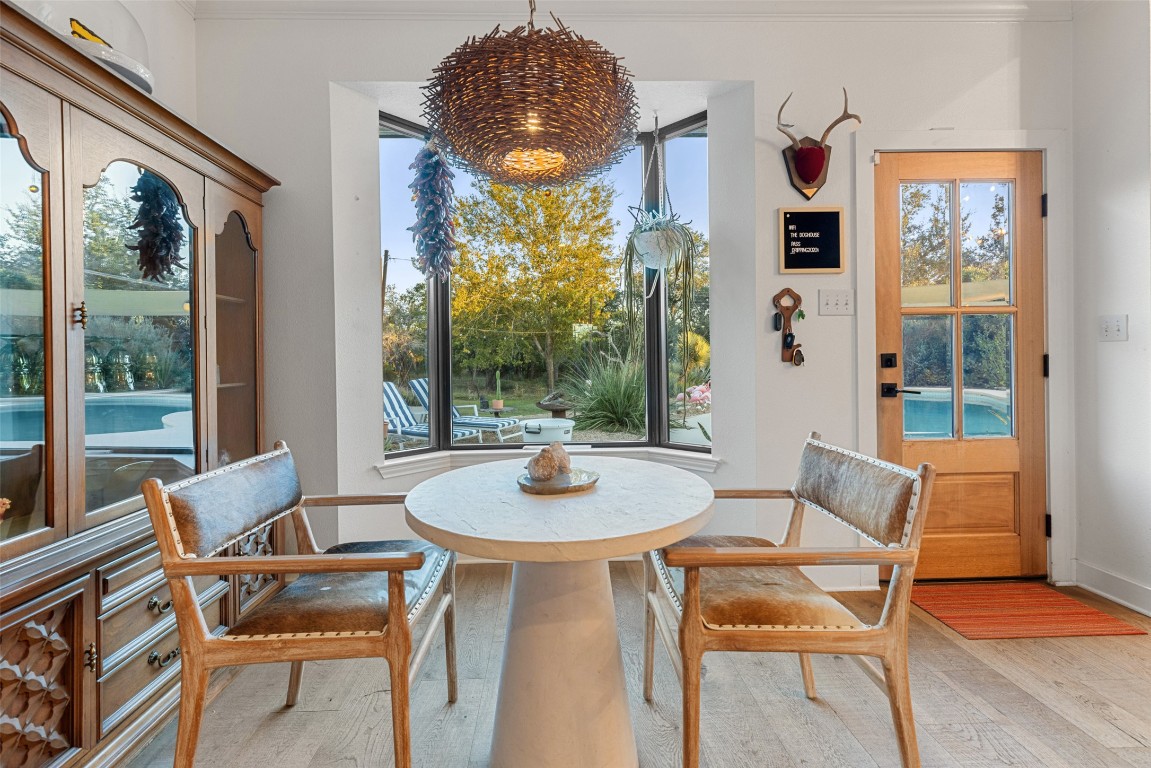 120 Oak Springs Drive Dripping Springs, TX 78620 - Photo 25 of 35 Dining space with light wood-style flooring and crown molding